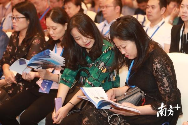 与会嘉宾翻阅大会宣传册。南方日报记者 朱洪波 摄
