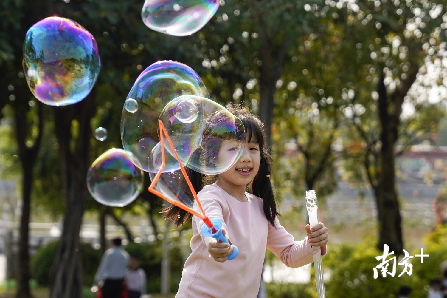 2月21日，广州阳光明媚，小朋友在广州儿童公园草坪上玩泡泡。南方日报记者 张冠军 摄