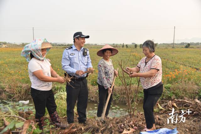 李健祥(左二)深入田间地头访民情、听民意。