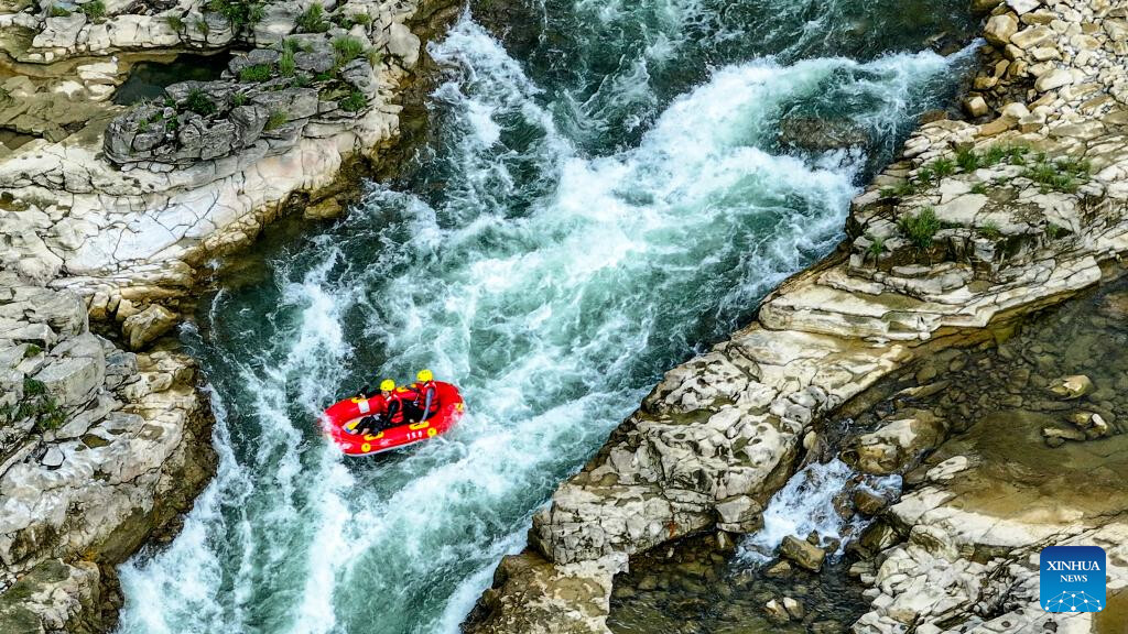 People raft in inflatable boats on Luobei River in Guizhou