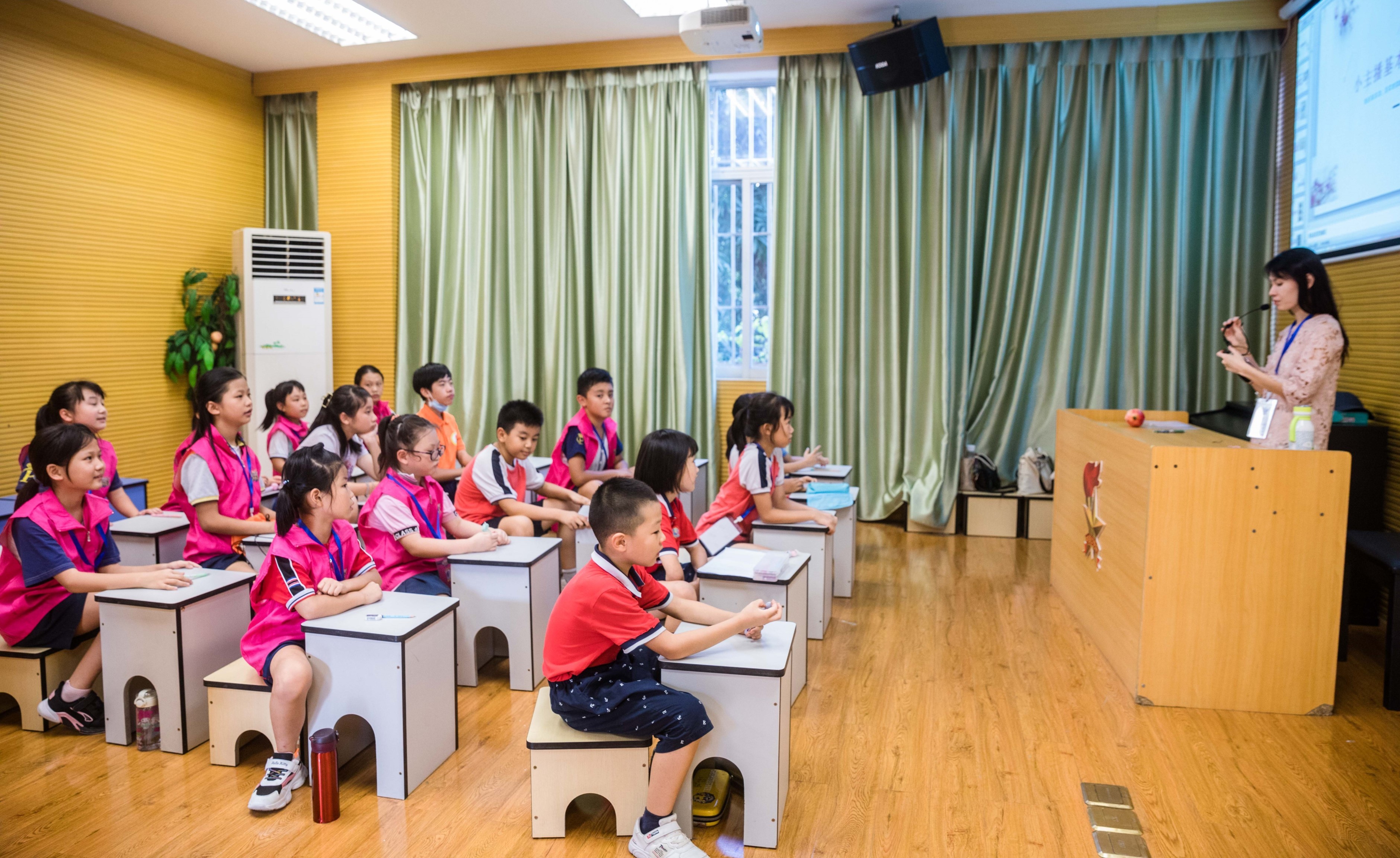 玫瑰小学的小主持兴趣班上，学生们跟随老师练习发音。（摄影：王伟楠）