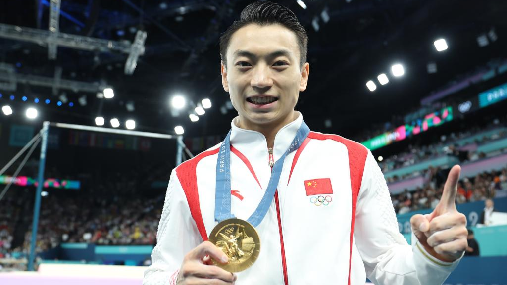 Zou Jingyuan of China celebrates after the men's parallel bars final of artistic gymnastics