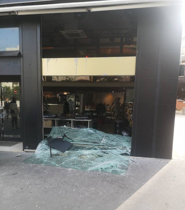 巴黎13区华人街一商铺遭袭后，落地窗玻璃掉落一地。  