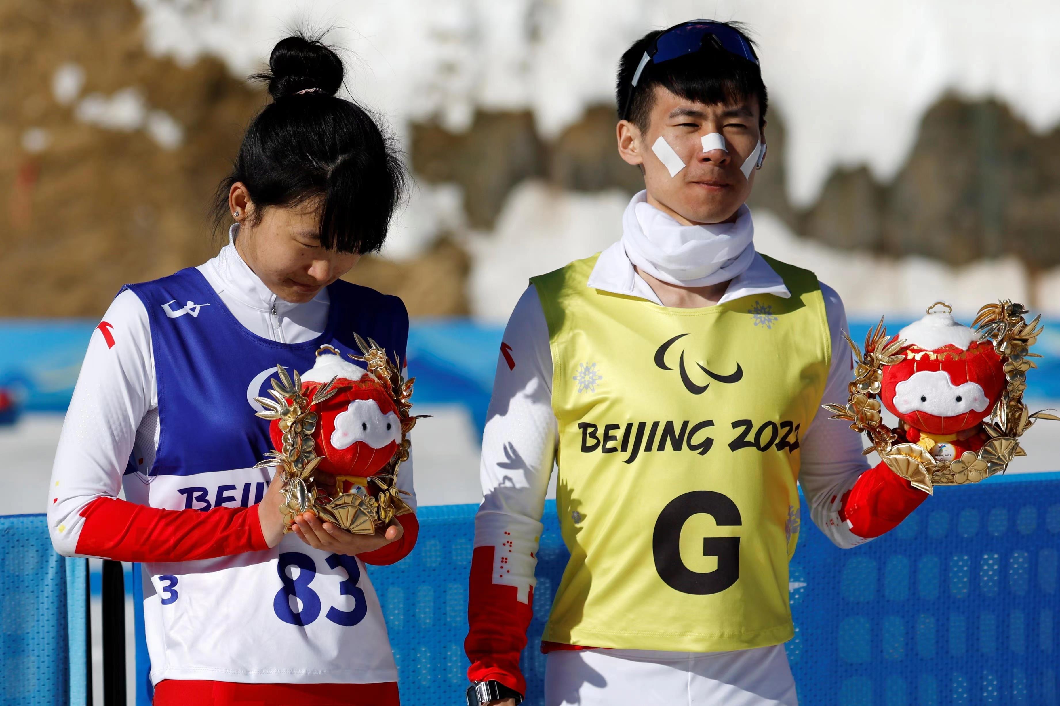 2022年3月8日，在2022冬残奥会残奥冬季两项女子中距离（视障）比赛中，中国选手王跃（左）获季军。