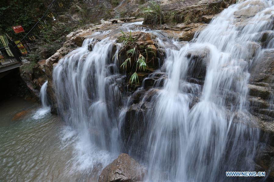 Tourists visit Tianzi Mountain waterfall scenic area in Guangdong