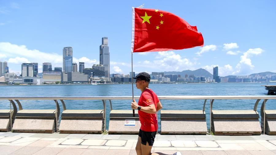 The "running man" of Hong Kong: celebrating patriotism with Chinese national flag