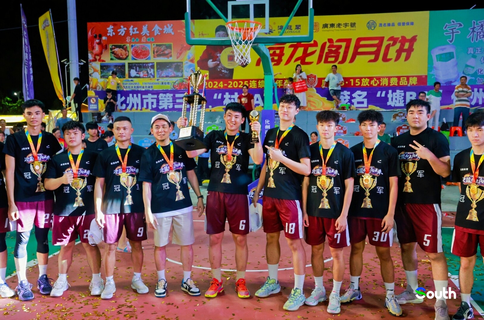 The championship team lifts the trophy in celebration.