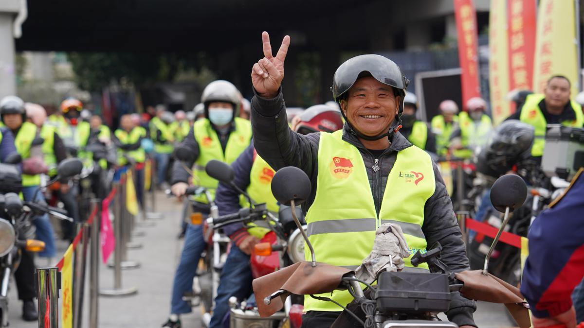 Migrant workers on motorcycles receive free gifts on their way home