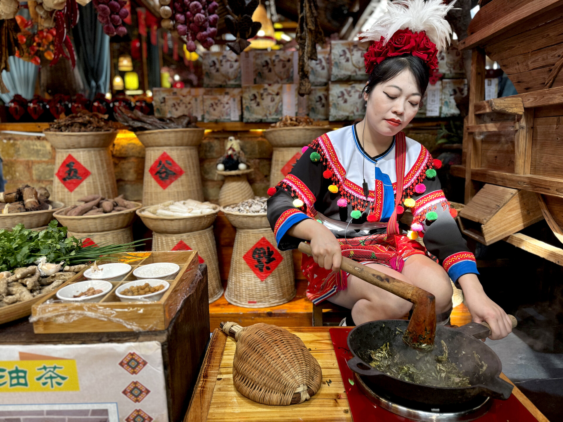 A Yao girl cooks a local oil-tea dish at a restaurant in Liannan Yao Autonomous County, Qingyuan, Guangdong