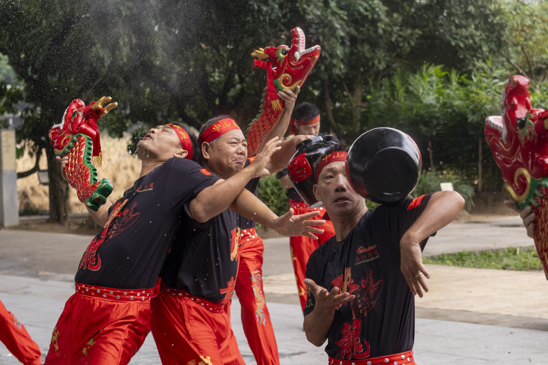 Three Drunken Dragon performers are in the moment, Former Residence of Dr. Sun Yat-sen in Cuiheng Village in Zhongshan, Guangdong