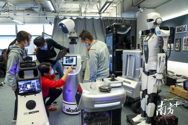 在香港数码港路邦科技公司，香港青年创业者麦骞誉和团队正在讨论最新研发的机器人。