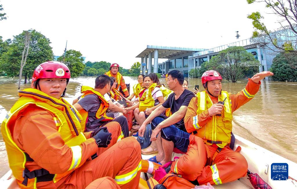 　　在河南省郑州市中牟县，李胜利（右一）在疏散被困群众（2021年7月22日摄）。新华社发（田聪 摄）
