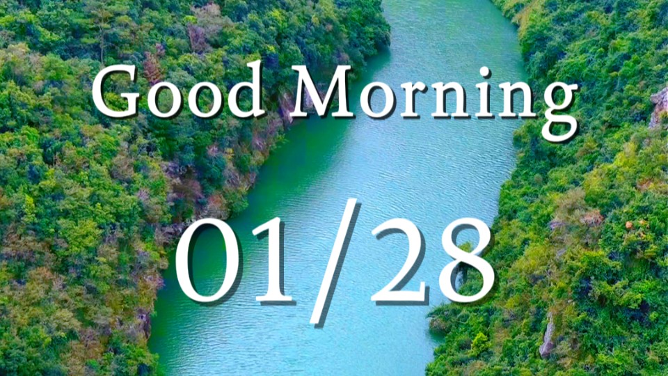 Vast expanse of emerald water stretches wide to embrace towering mountains