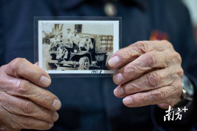 肖开向记者展示当年和战友的合照 