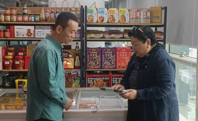 东盟中国工商总会广东分会会长李懿静（右）和广州雪印食品股份有限公司总经理李煌（左）交流