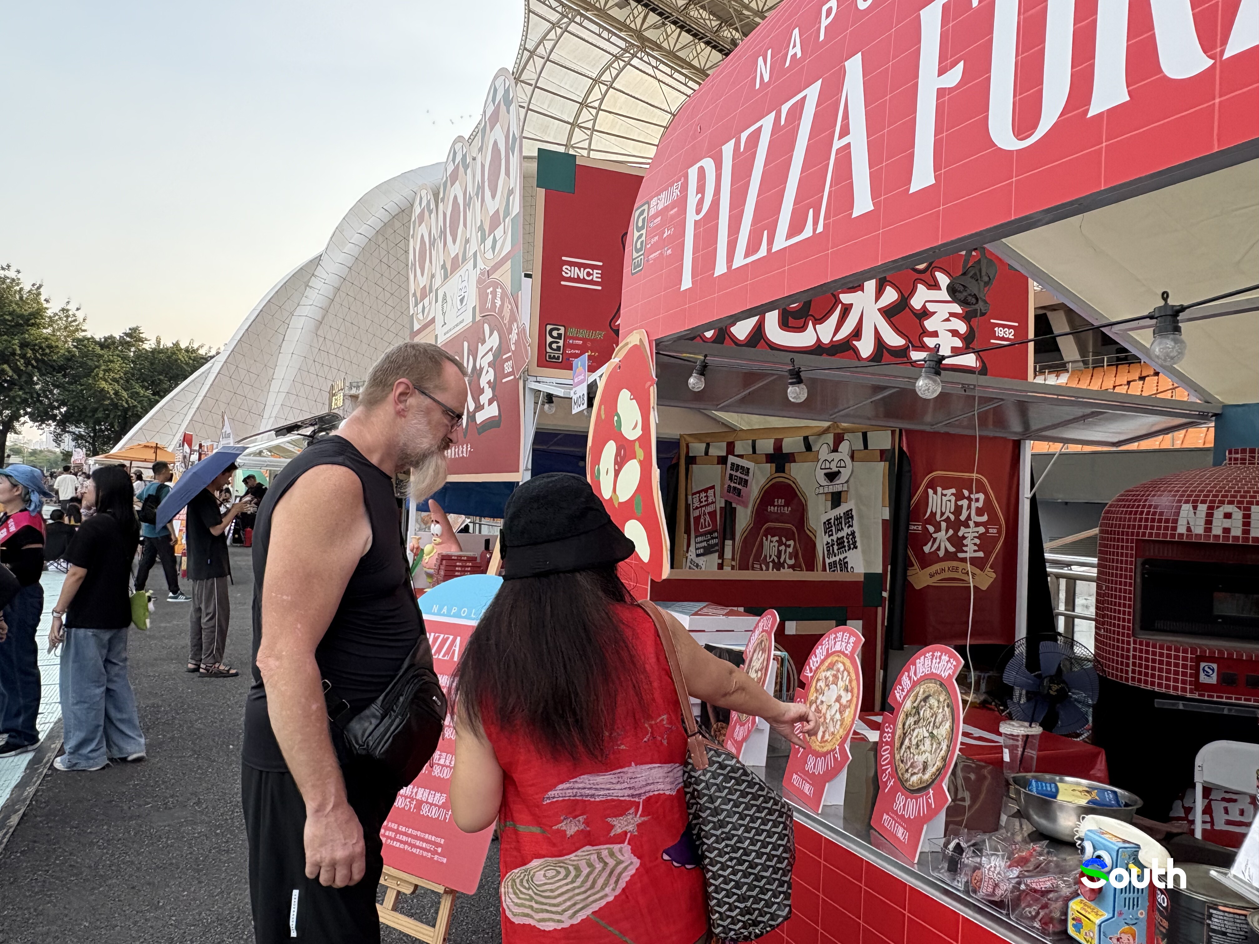 An international visitor browses the diverse food stalls at the event.