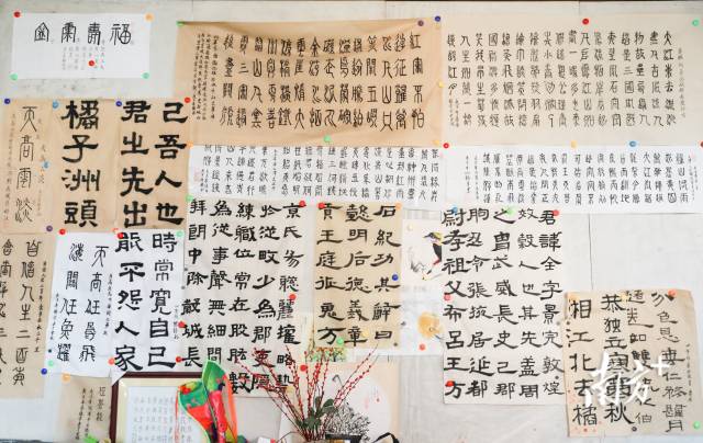 客厅里一整面的展示墙上，全是三代人的书法作品。