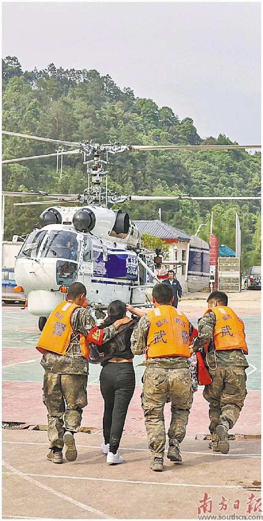 救援人员带领灾区群众乘坐直升机转移。    南方日报记者 郑新洽 董天健 摄
