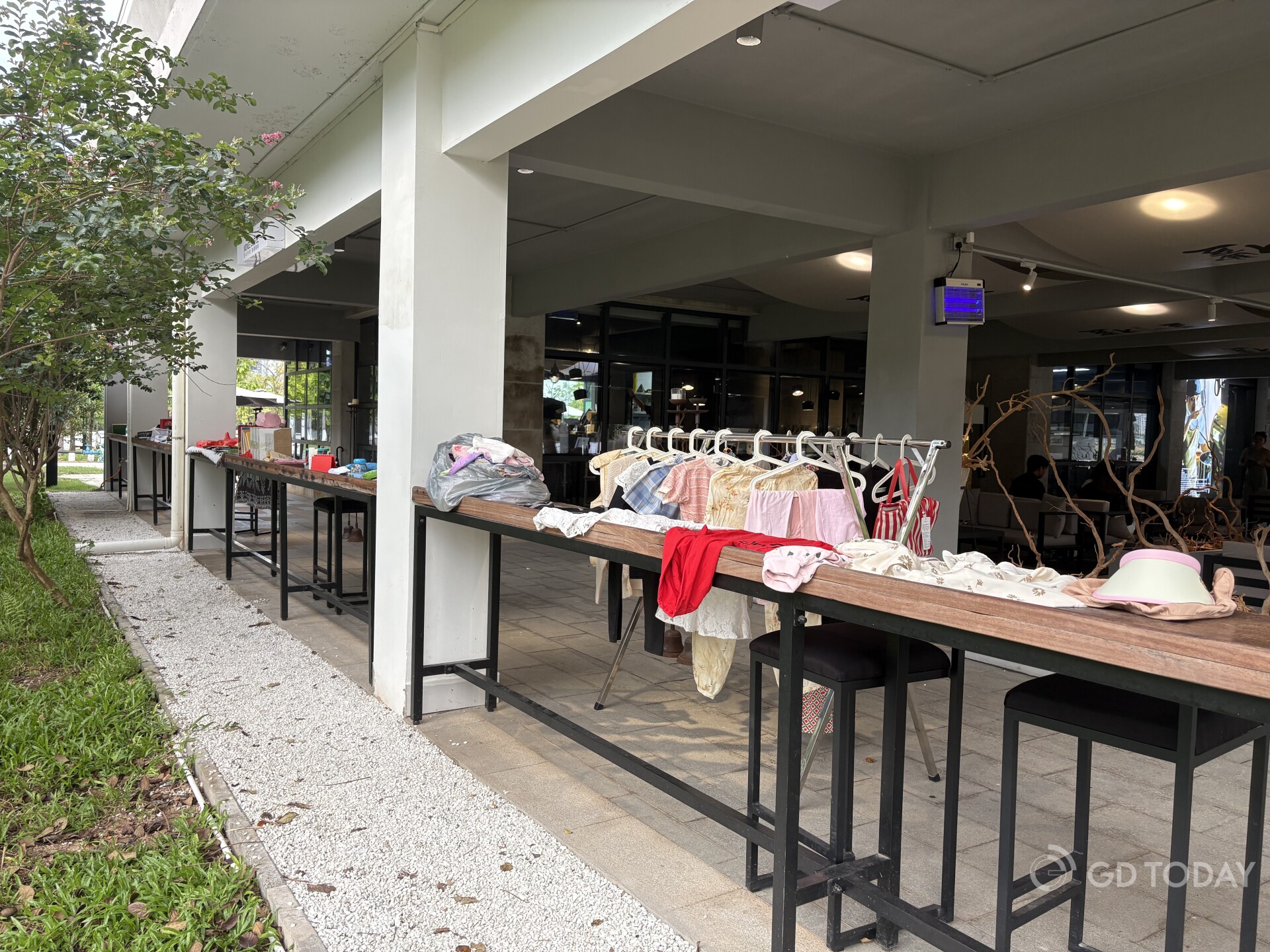 Donated second-hand items in the event lined up on four long tables in a cafe in Nansha.