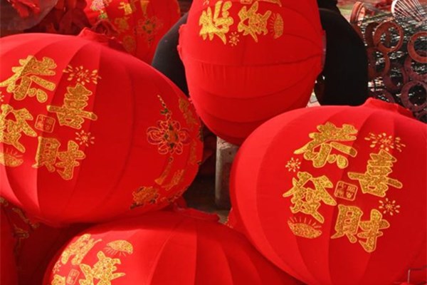 Worker make red lanterns to fulfill rush orders ahead of Chinese Lunar New Year