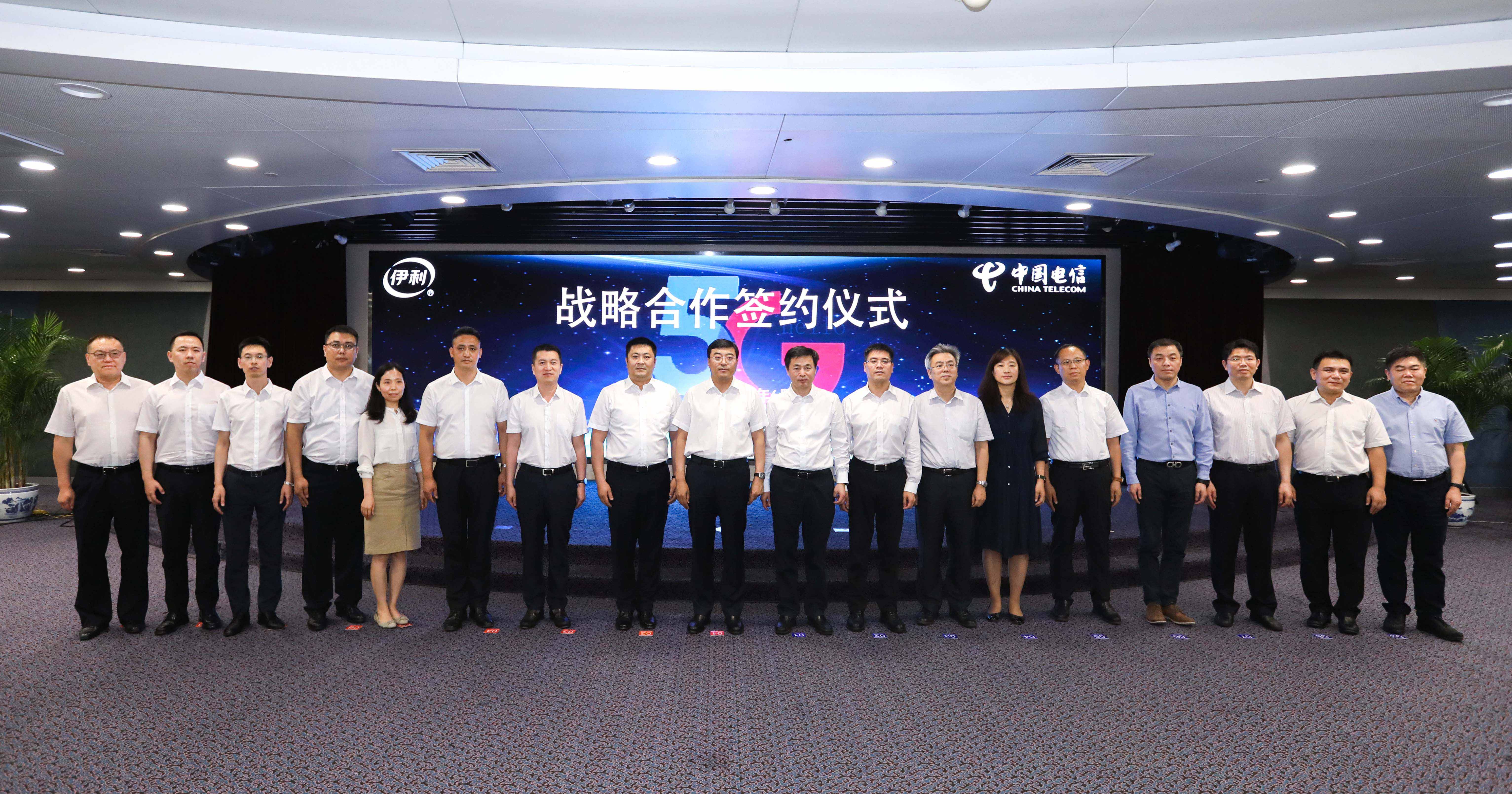 在伊利集团董事长潘刚（左9）与中国电信董事长柯瑞文（左10）的见证下，双方签署5G战略合作协议