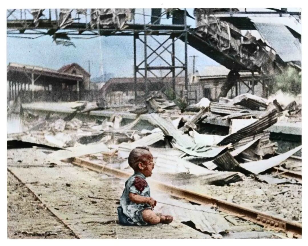 1937年淞沪会战期间,王小亭拍摄被日军轰炸后的上海车站,图为其中一名浑身是血的婴儿坐在地上大哭的大幅新闻老照片。(邹德怀收藏+上色)